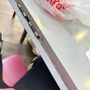 a person sitting at a table with a hot dog