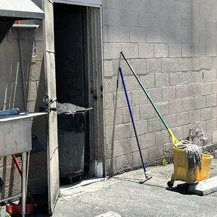 a mop and bucket outside of a building