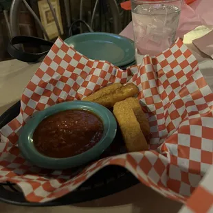 a basket of food and a glass of water