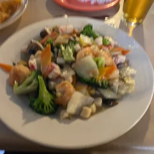 a plate of food and a glass of beer