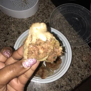 a person holding a piece of food