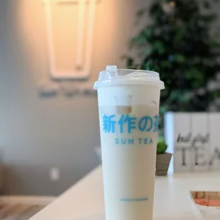 White peach oolong milk tea with cheese foam