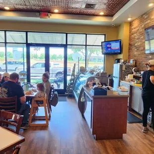 people sitting at tables in a restaurant