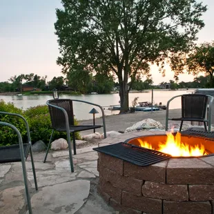 a fire pit with chairs around it