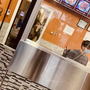 a man sitting at a counter in a restaurant