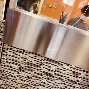 a man behind a counter in a restaurant