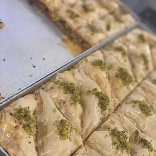 a tray of baklaa cut into squares