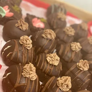 a tray of chocolate covered donuts