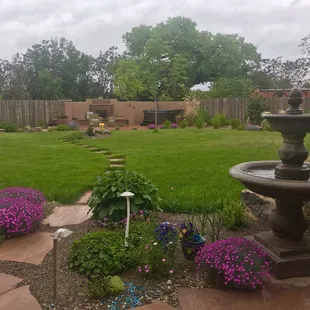 Fountain, grass, plants, lighting, walkway, fence, fireplace, drip watering system all installed by Sunbelt Landscaping