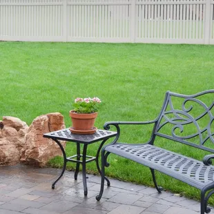 a bench and table in a backyard