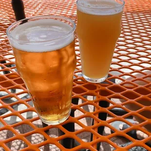 two glasses of beer on a table