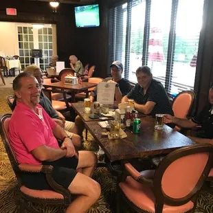 Golfers relax after with a beer after a round at the Suncrest golf course.
