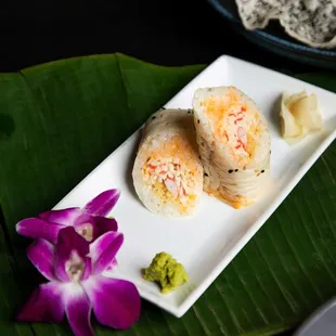 a plate of sushi and a flower