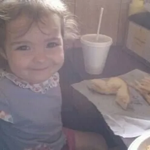 a little girl sitting at a table
