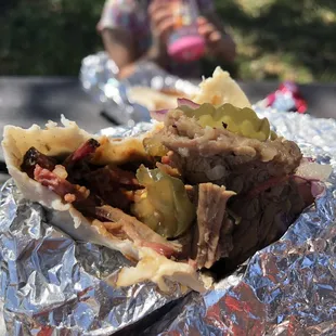 a hand holding a sandwich