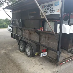 The trailer on the side of the road.