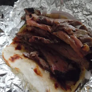 This is the brisket taco, backside, with onions only (no pickles). OMG.