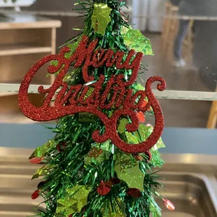 a christmas tree decorated with red and green tinsel