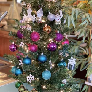 a small christmas tree with ornaments