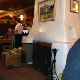 Adobe brick fireplace in center of restaurant make for a cozy dinner!!