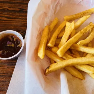 a basket of french fries and a cup of ketchup