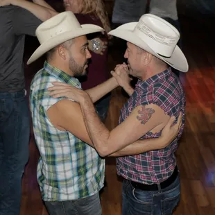 two men in cowboy hats dancing
