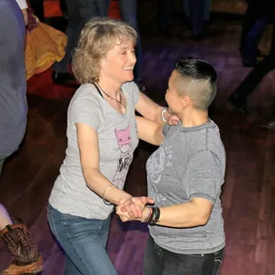 a woman dancing with a young man