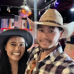 a man and a woman wearing cowboy hats
