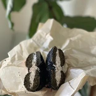 black sesame and harissa bagel with red onion and caper spread