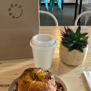 Coffee and green chili cheese bagel with cream cheese