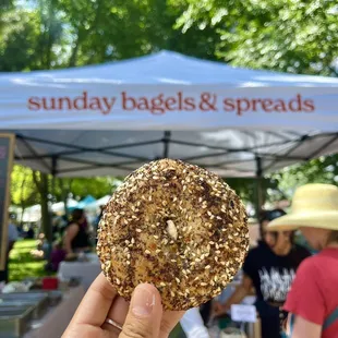 a person holding up a donut