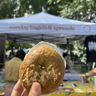 a person holding up a doughnut