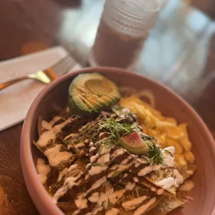 Birria chilaquiles with added avocado and added egg