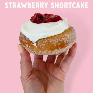 a hand holding a strawberry shortcake