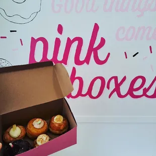 a pink box of doughnuts