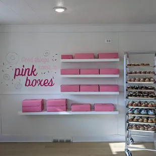 pink boxes on shelves in a bakery