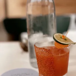 a bloody cocktail with a lime slice on the rim