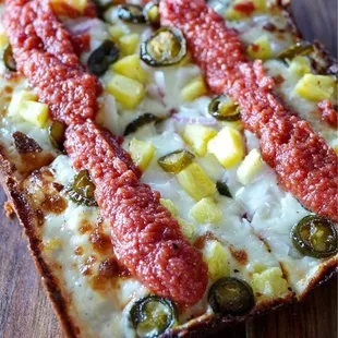 a slice of pizza on a wooden table