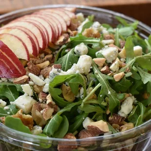 a bowl of salad with apples and blue cheese