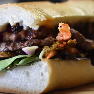 a sandwich with meat and vegetables