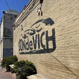 the name of a restaurant painted on a brick wall