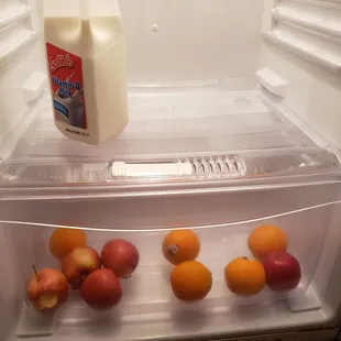 Left over food in fridge with half eaten apple