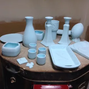 Dipped painted pieces before being placed in the kiln.  the glaze turns clear in the kiln!