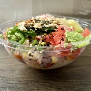 Poke bowl with sushi rice, ahi poke, salmon, and shrimp