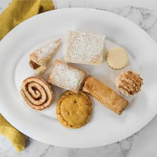 a plate of pastries and desserts