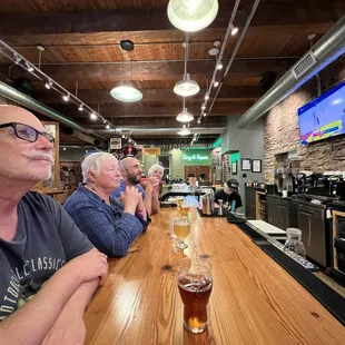 Watching KU basketball with friends at the bar counter.