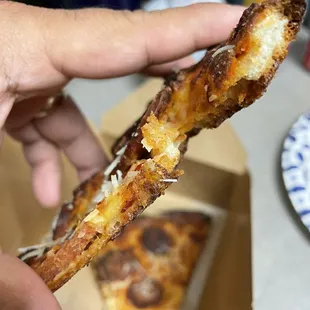 Metal on piece of pizza.