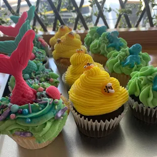 a row of cupcakes with colorful frosting