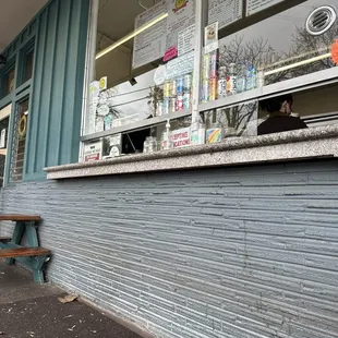 a man sitting on a bench in front of a store