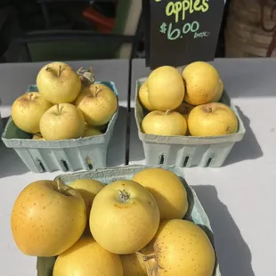 two baskets of yellow apples